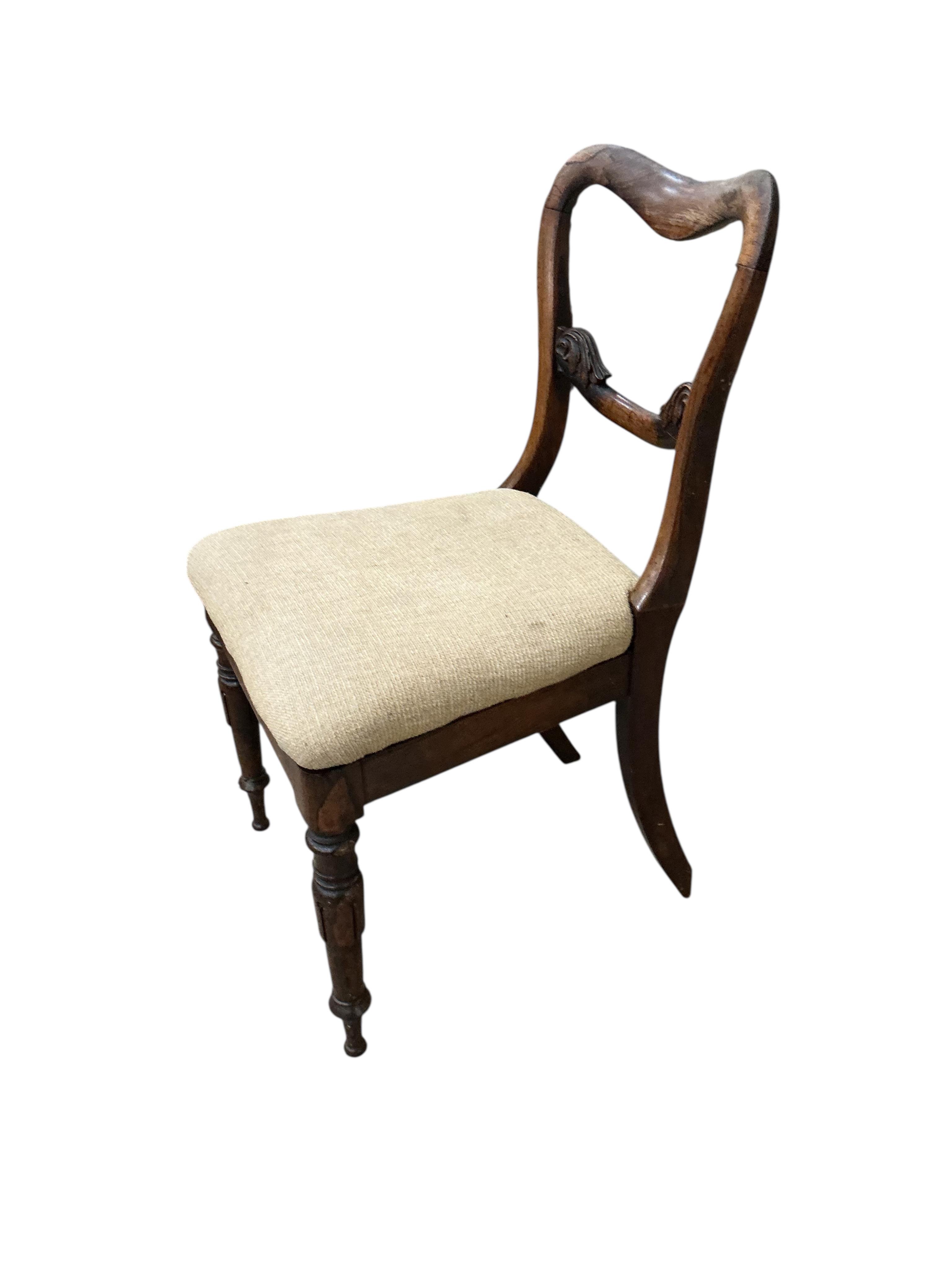 A set of four early Victorian rosewood dining chairs with drop in seats